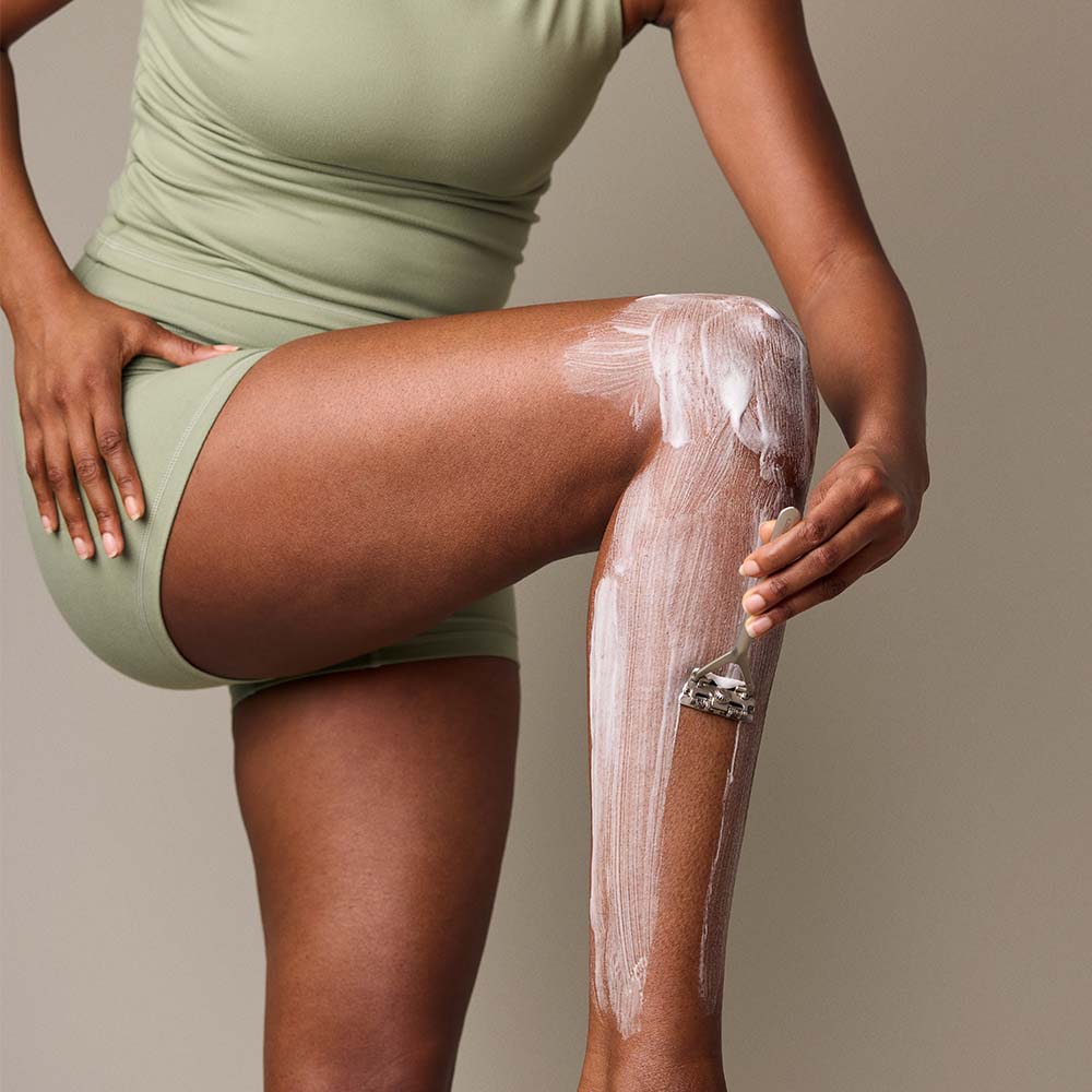 woman shaves her leg with Leaf razor