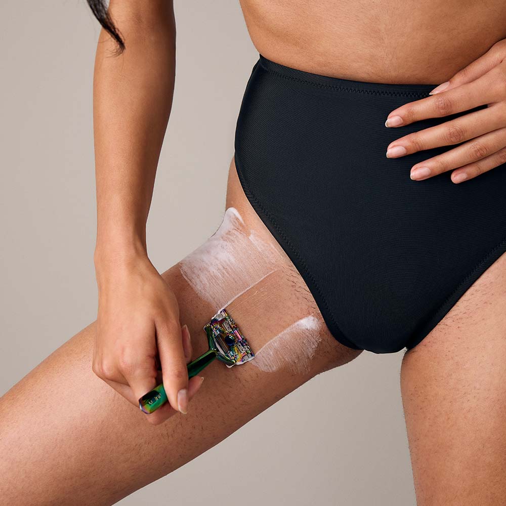 Woman shaves her groin with the leaf razor