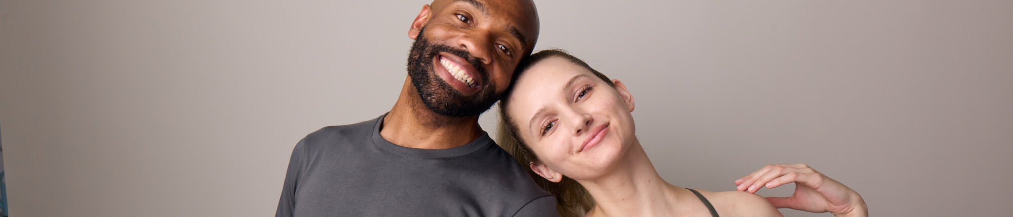 Man and women smile together with his head on top of hers