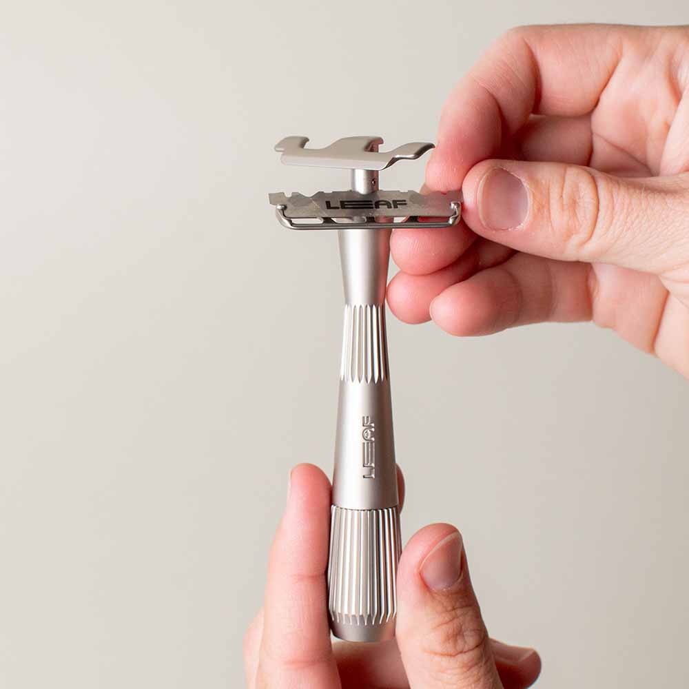 User adjusts the blade of a single edge razor