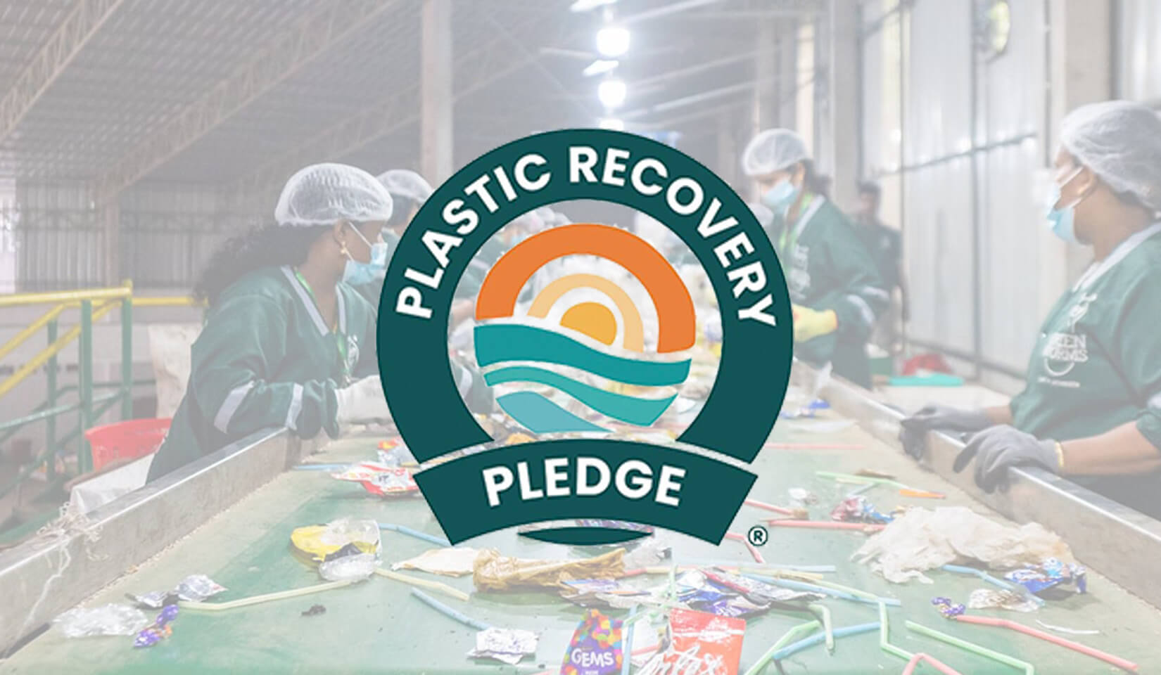 logo of plastic recovery pledge against a backdrop of a recycling sorting center