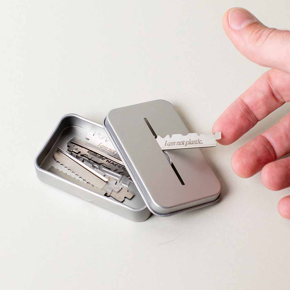 User puts a blade through the slit of the recycling tin with the lid off