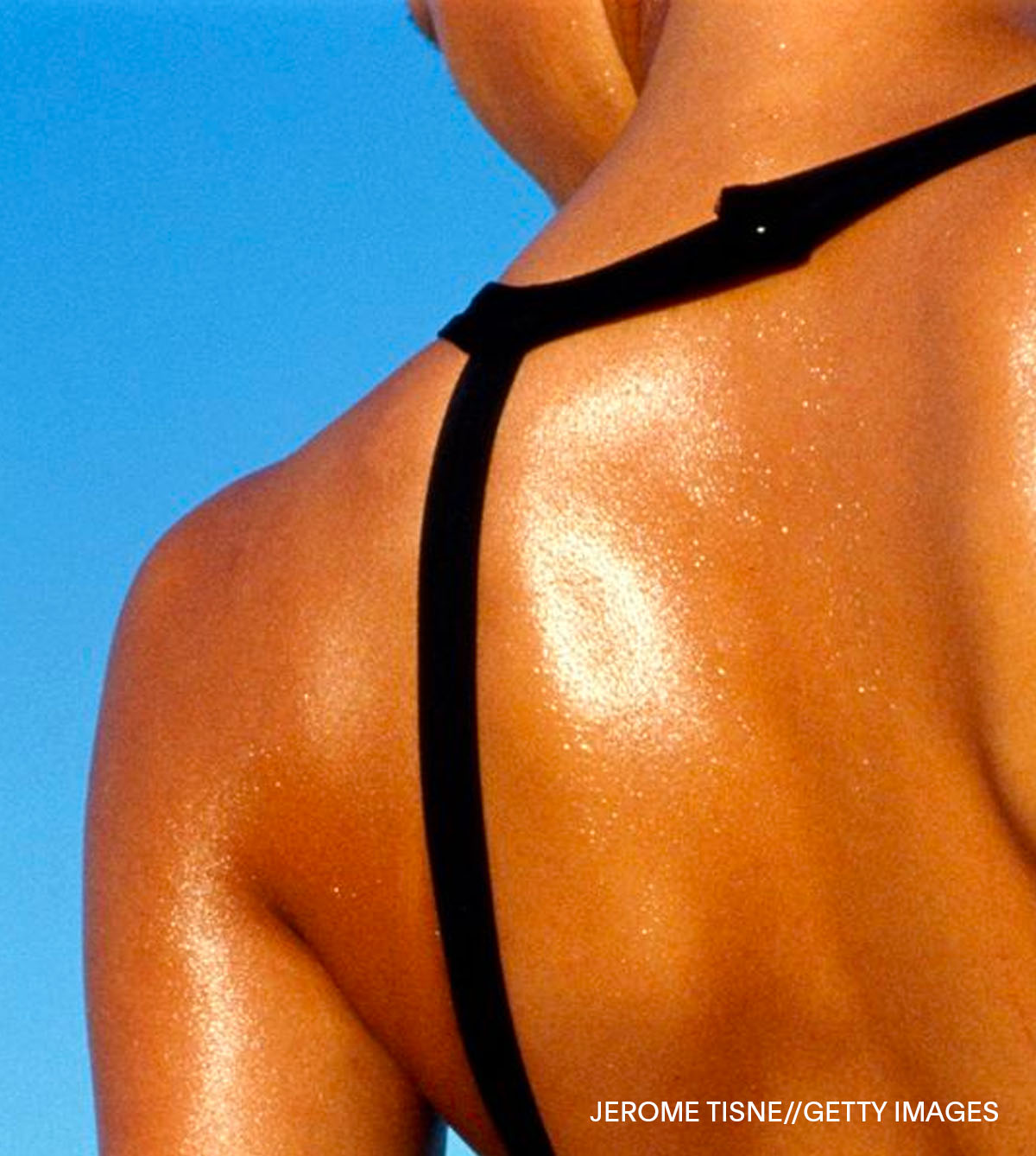 Women in black bathing suit with her back to camera. Photo by JEROME TISNE//GETTY IMAGES