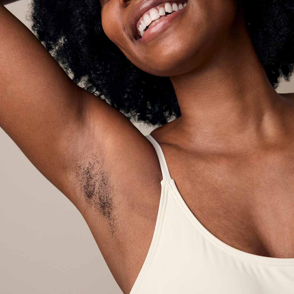 Woman shows her under arm hair