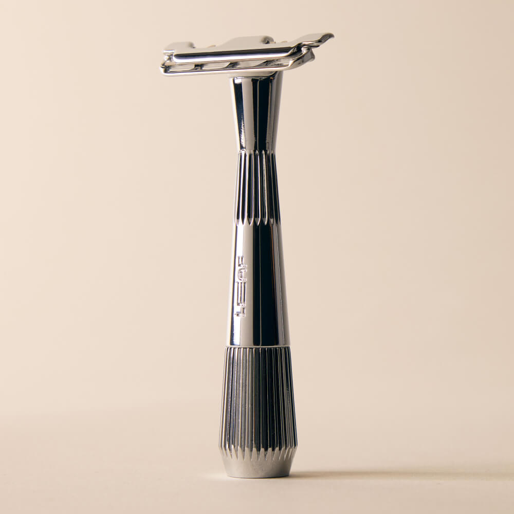 Chrome single edge razor standing by itself