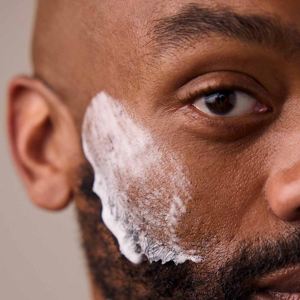 Man has shave soap on his cheek