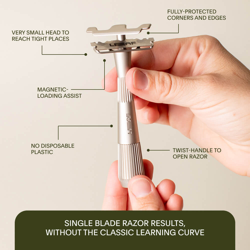 A single edge razor being held in the air with its features