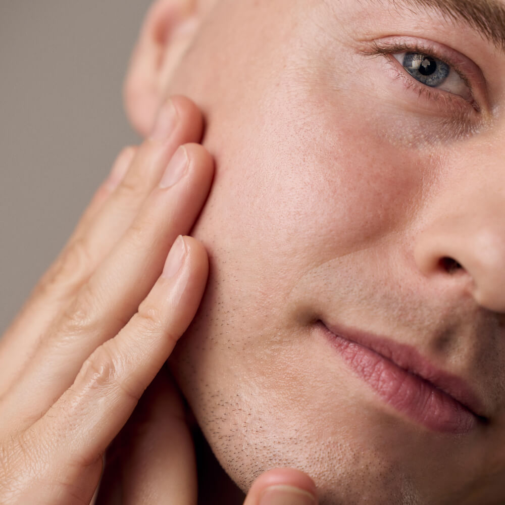 Man feels his smooth cheek