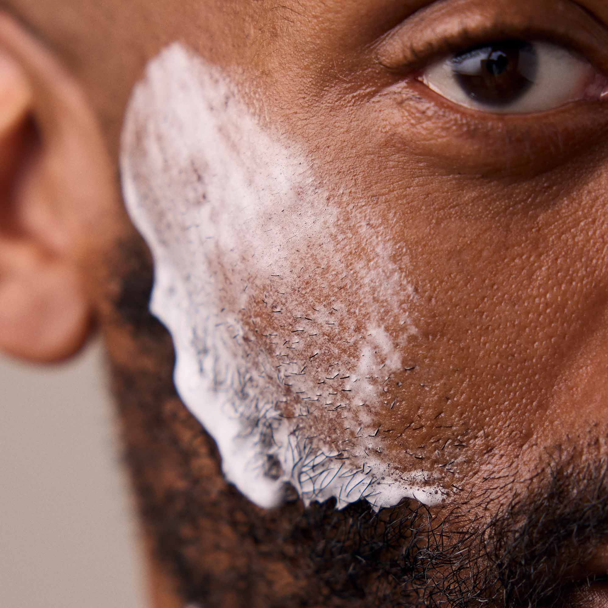 Shave soap on a man's cheek