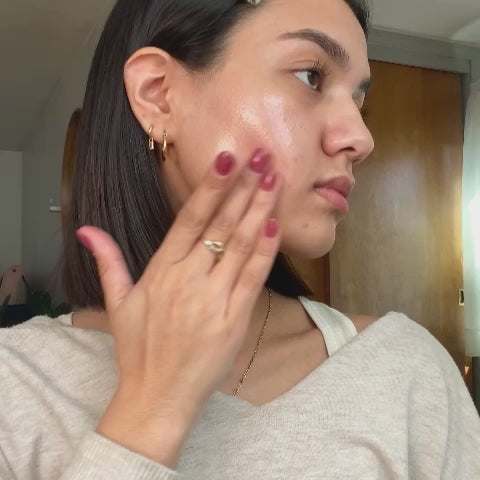 Woman uses dermaplaner on her cheek